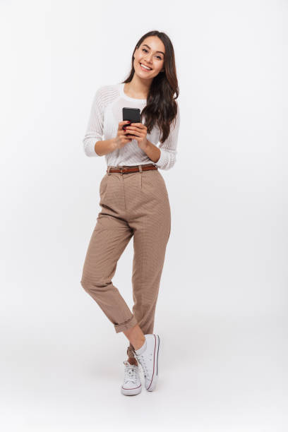 Trendy casual outfit for ladies with high-waisted trousers and a relaxed-fit blouse, styled for versatility."
