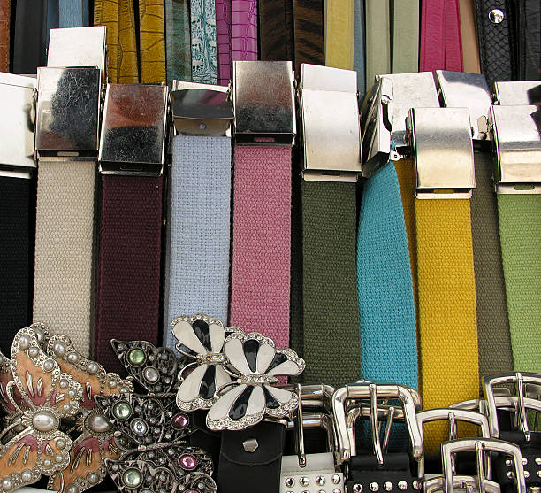 A close-up of a statement belt cinching a loose dress, adding structure and style to the outfit.