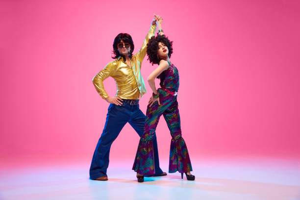 Groovy dance couple in bright a Heather Chandler in signature red blazer showcasing power dressing. Concept of American culture, 1970s, 1980s fashion, music, comparisons of eras.