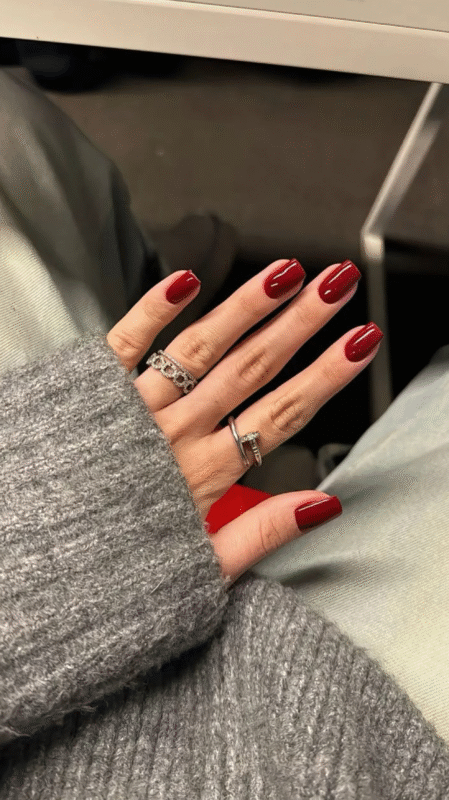 Elegant woman showing off her freshly painted red nails