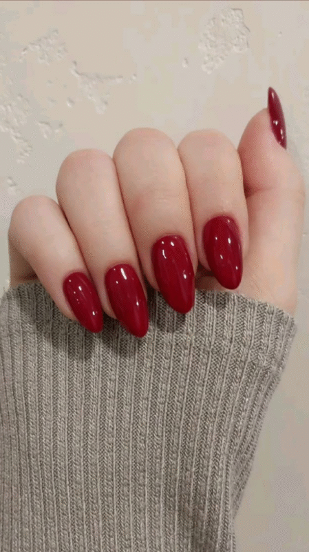 Bright red nails with gold glitter accents for a festive look