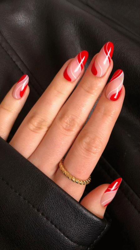 Long almond-shaped red nails with a glossy top coat